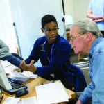 A Trinity College student assisting the community with accounting skills